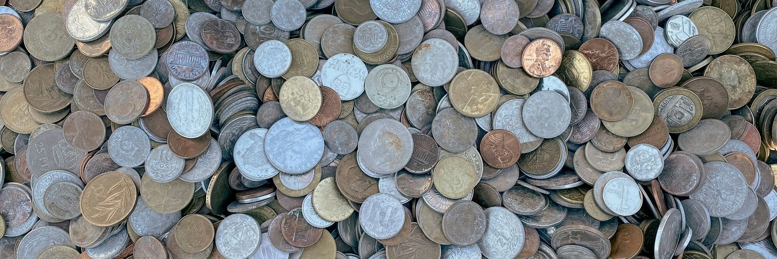 a pile of different types of coins