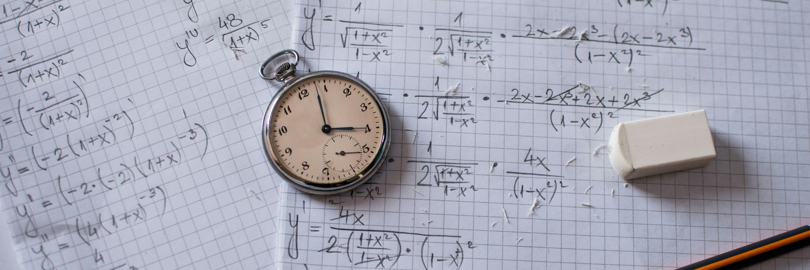 silver and white round analog watch beside white printer paper
