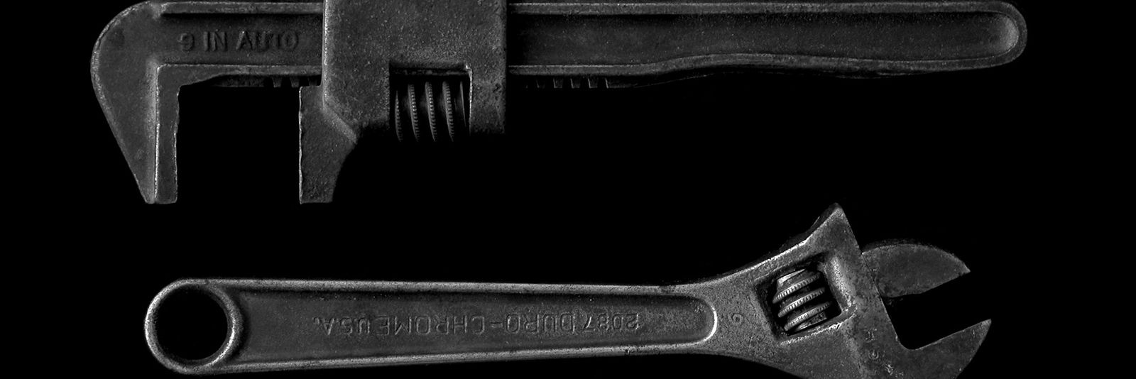 gray adjustable wrench and gray pipe wrench