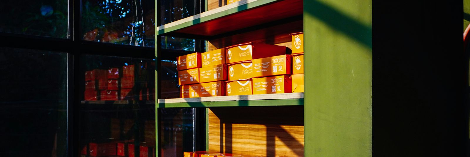 Shelves filled with orange boxes in natural light