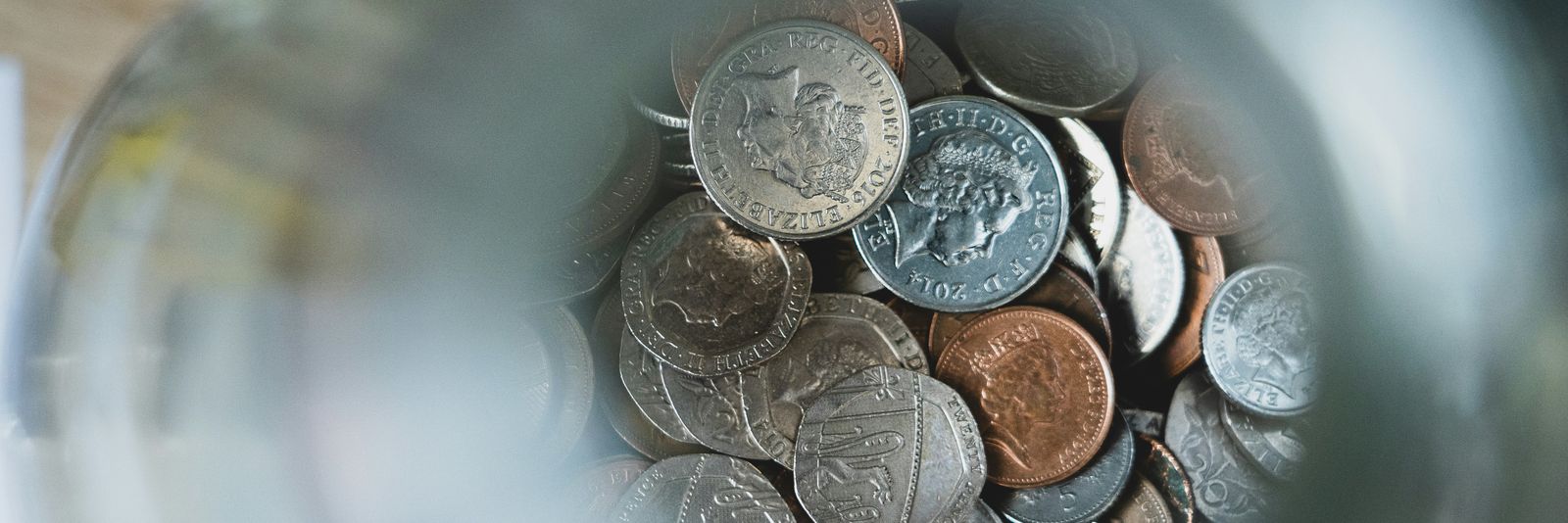 silver round coins on blue round container
