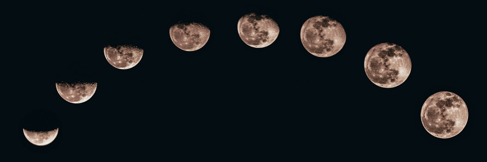 A sequence of moon phases forming an arc against a dark night sky