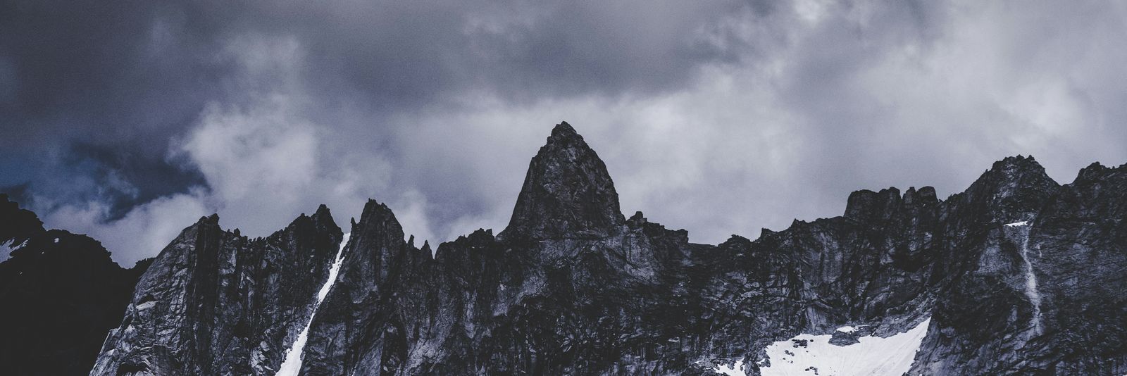 snow covered mountain under white clouds
