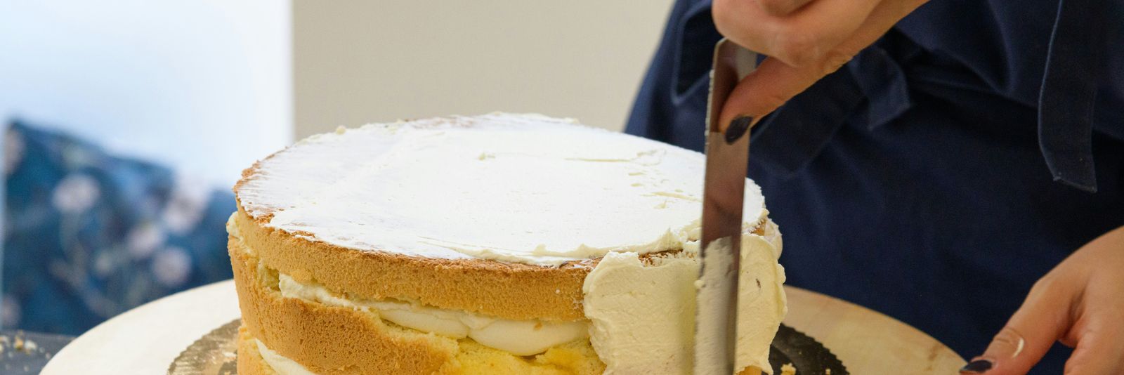 a person cutting a cake with a knife