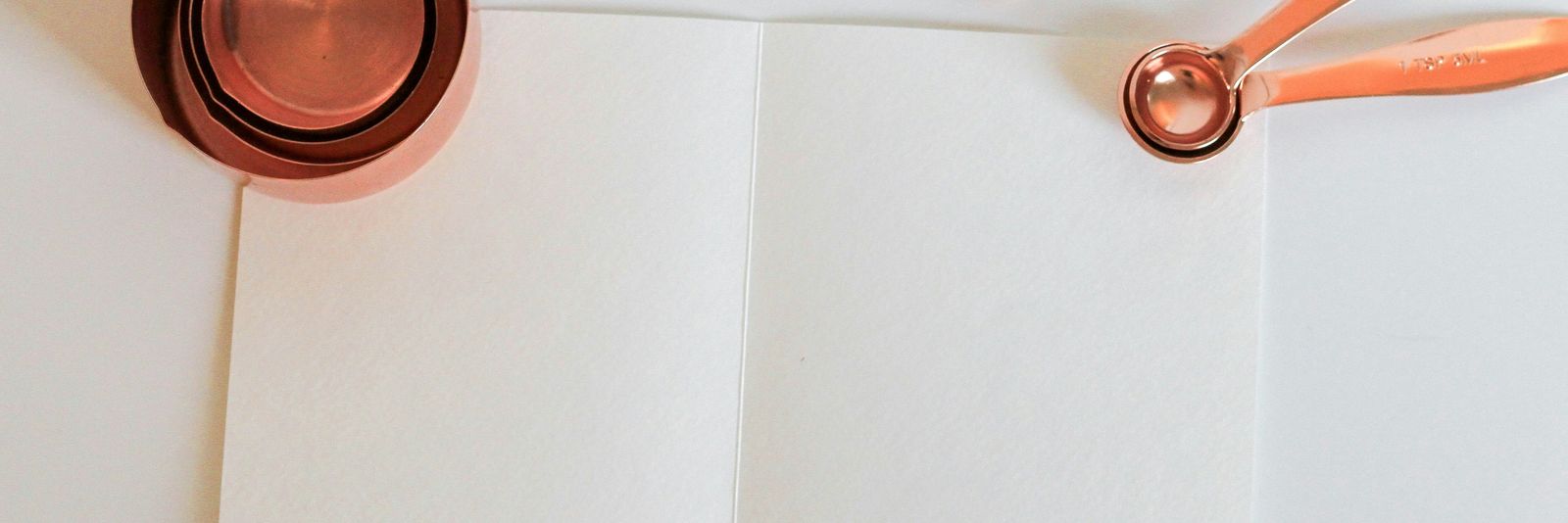 measuring cup on white paper