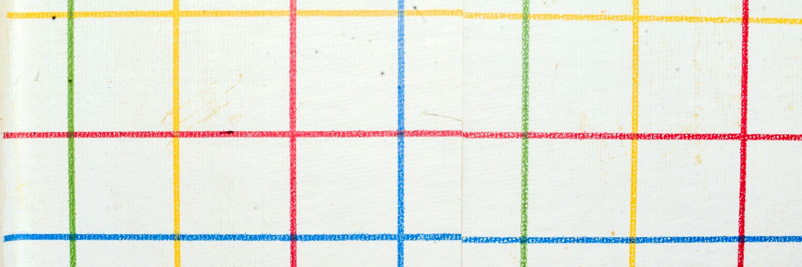 A grid of intersecting red, blue, yellow, and green lines on white paper