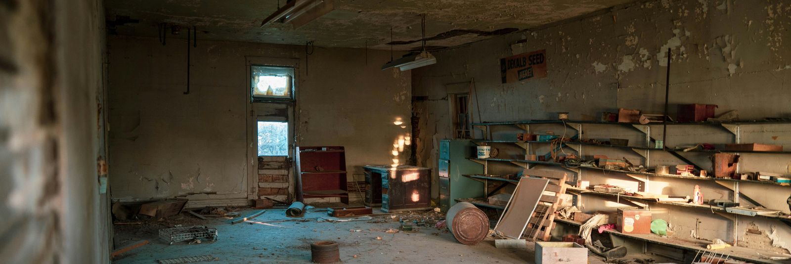 Dilapidated abandoned room with debris and sunlight from a window