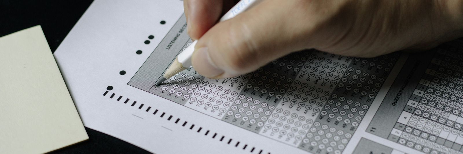 person writing on white paper